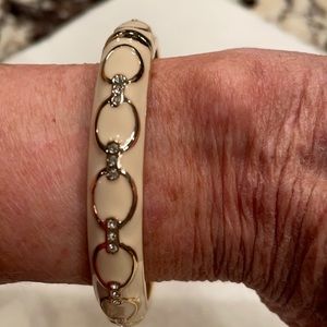 Cream and gold colored bangle bracelet